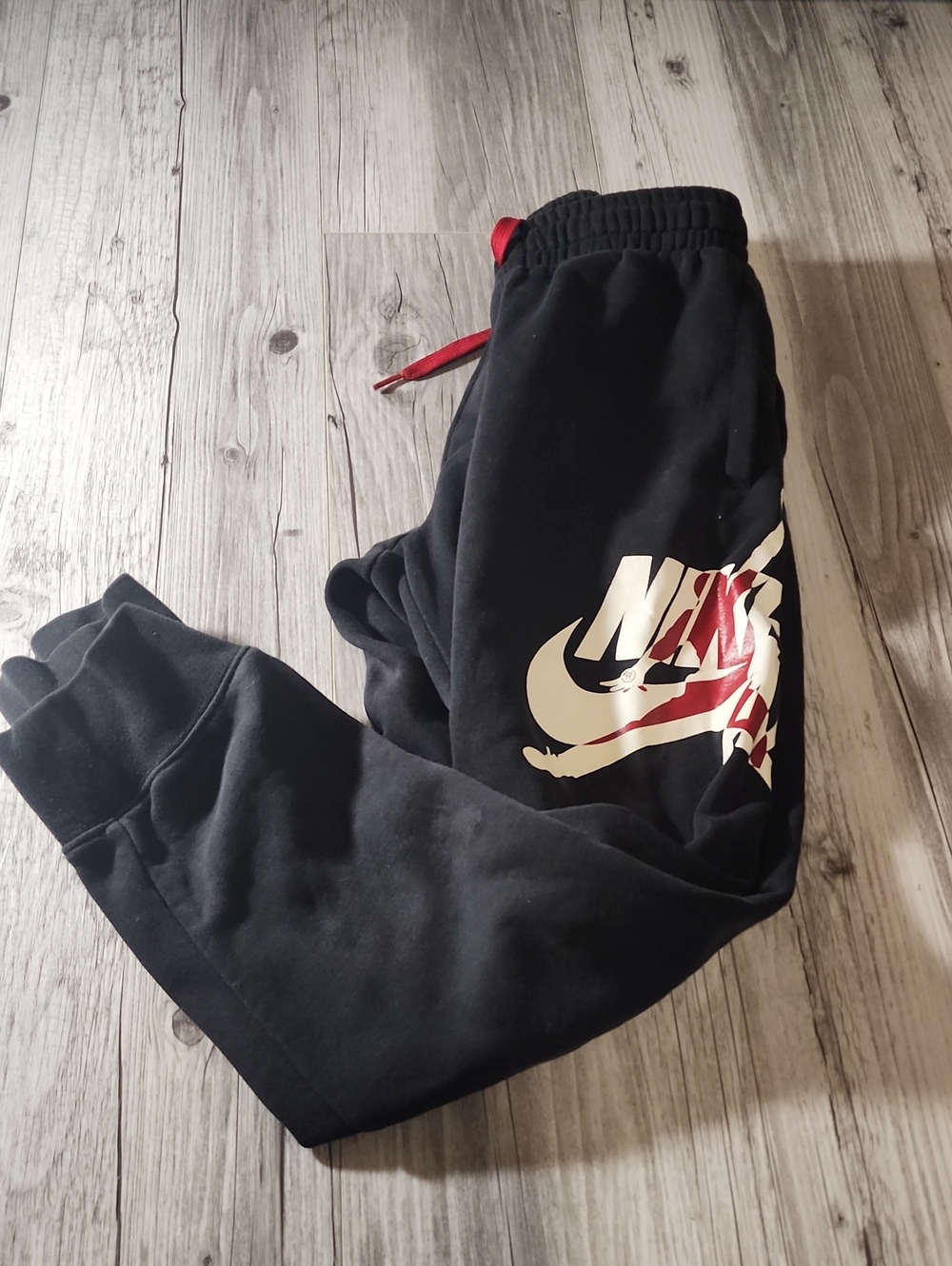 Nike Black Sweatpants with White and Red Swoosh Graphic